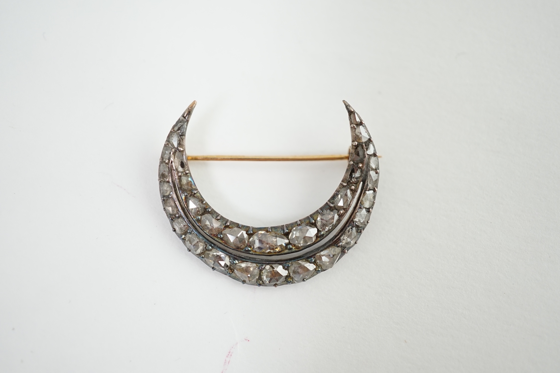 A 19th century gold, silver and graduated rose cut diamond set two row crescent brooch